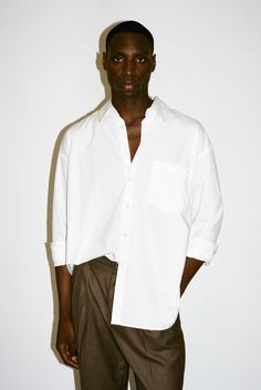 An ultra-crisp button up shirt with the effortless proportions of 90's Wall Street. Worn untucked or half-tucked, this oversized, billowy office staple makes for the ultimate off-duty move. Constructed from 100% pima cotton, a superior high-grade cotton known for it's incredible softness. Modern Oversized Button-up Tops, Relaxed Fit Dress Shirt For Summer Daywear, Oversized Effortless Shirt With Shirttail Hem, Oversized Button-up Shirt For Daywear, Oversized Tops With Button Cuffs For Business Casual, Classic Oversized Tops For Workwear, Modern Oversized Shirt For Office, Oversized Collared Shirt For Work, Oversized Button-up Shirt For Office