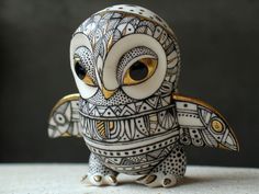 an owl figurine sitting on top of a table