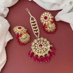 Kundan and pearl jhumka earring and tika set in Yellow, peach, Hot pink and  green color. Inspire your style with delicate lightweight jhumka and pearl chain tika in gold finish. A perfect piece of jewelry to give it as a gift to your loved ones.  All orders Ship same day if placed before 4:00 PM EST  Earring Length: 2.5 inch Earring Width: 1.15 inch Mangtika Length: 6.5 inch Create beautiful memory for any occasion with elegant jewelry for your loved ones We will be happy to navigate you throug Stone Work Bridal Earrings Gift For Eid, Adjustable Chandbali Jewelry For Wedding, Stone Work Bridal Earrings For Eid, Bridal Earrings With Stone Work For Eid, Bridal Earrings With Stone Work As Gift For Eid, Round Jewelry For Eid Weddings, Festive Dangle Tikka For Wedding, Eid Bridal Earrings With Tilla For Gift, Wedding Dangle Tikka With Latkans