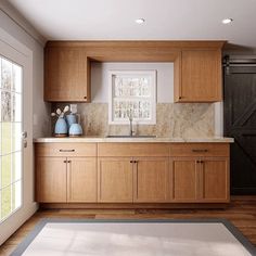 a kitchen with wooden cabinets and marble counter tops, along with an area rug on the floor