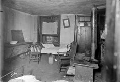 an old black and white photo of a bedroom