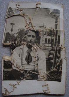 an old photo of a man wearing a suit and tie with chains around his neck