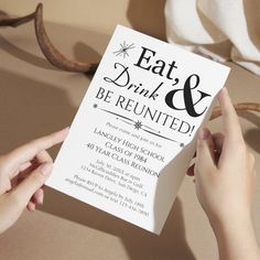 two hands holding up a card that says eat, drink and be reunited