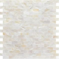 a white and beige tile wall with squares on it