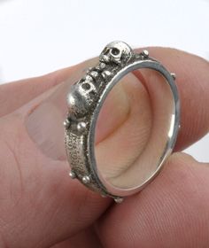 "The 2 Skulls Ring I get a lot of custom requests for a smaller skull ring, so here's my latest. Lots of detail - totally unique. Small enough for a women's hand but a nice size for a mans wedding or casual ring. 6mm (1/4\") wide It has a slight grey patina on the outside and a fine mirror polish inside. Handmade to order and cast in solid sterling silver (.925)." Adjustable Skull Ring For Anniversary, Adjustable Round Skull Ring For Anniversary, Unique Skull Shaped Anniversary Rings, Internally Threaded Sterling Silver Wedding Rings, Sterling Silver Skull Ring For Wedding, Skull Ring Stamped 925 For Anniversary, 925 Stamped Skull Ring For Anniversary, Unique Hallmarked Skull Ring For Anniversary, Symbolic Hallmarked Skull Ring For Anniversary