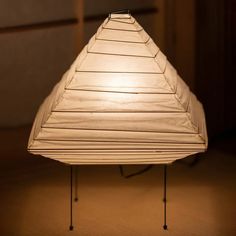 a white lamp sitting on top of a wooden table