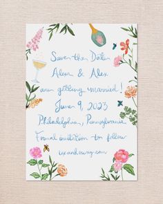 a wedding card with flowers and wine glasses on the front, printed in blue ink