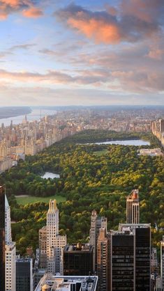 an aerial view of new york city with the central park in the foreground at sunset