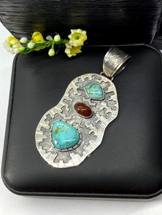 "Artisan Turquoise and Mexican fire Opal pendant Hand-made Sterling Silver 925. Stones used: Turquoise (Nevada), Mexican Fire Opal. Height -3\" (including bail), Width - 1 1/4\" Height - 75mm (including bail), Width - 35mm Unique Handcrafted One-of a-kind Design Pendant Each Piece of Jewelry in my Collection is Absolutely One of a Kind! When you start wearing a piece of my jewelry you will fall in love with it more and more each day and feel that good Energy and Love that I pass into it while cr Unique Untreated Turquoise Pendant Necklace, Turquoise Pendant In Sterling Silver, Turquoise Sterling Silver Pendant Gemstone, Turquoise Pendant Gemstone In Sterling Silver, Unique Turquoise Rectangular Pendant Jewelry, Handmade Turquoise Gemstone Pendant, Unique Collectible Turquoise Necklace, Turquoise Natural Stones Pendant Gemstones, Turquoise Pendant Gemstone