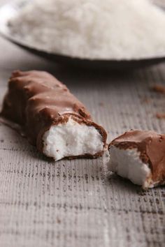 two pieces of chocolate covered marshmallows on a table