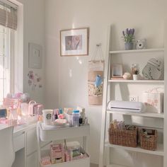 a white desk with lots of craft supplies on top of it in a home office