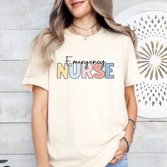 This cute and minimalist nurse t-shirt is perfect for those who work hard, care harder, and do it all with a smile. 🥰 Crafted from super-soft, breathable fabric, it's comfy enough for those long shifts or a casual day off. Pair it with your favorite scrubs, jeans, or leggings for an effortlessly cool look -- because we know you like to keep things low-key but meaningful.  ❤️🩺💉 🩺PRODUCT DETAILS: - Solid Colors:  100% airlume combed and ring-spun cotton - Heather Colors: Cotton and polyester blend - Super soft, breathable fabric - Unisex sizing - Retail Fit - Pre-shrunk 🩺PROCESSING TIMES Production: 3-7 business days Standard shipping: 3-12 business days Orders are processed in a first in, first out basis. Thus, we are NOT able to rush production. For expedited shipping options, please Nurse Clothing, Nurse Retirement Gifts, Aesthetic Nurse, Gifts Aesthetic, Nurse Tshirt, Nurse Appreciation Gifts, Cute Nurse, Nursing Clothes, Retirement Gift