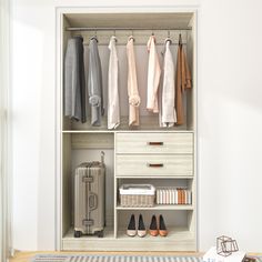 an open closet with clothes and shoes hanging on the wall next to a rug in front of it