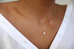 This dainty necklace features a small oval genuine Freshwater sits on a dainty and fine finish 18k gold-filled chain. You can wear this dainty necklace with your everyday jeans as well as on a night out. It will always look beautiful on you.     D E T A I L S  * Pearl measures approx 4mm * Due to the one-of-a-kind nature of the stones they may vary slightly in size color, hue, and reflection. Please note: This listing is for one necklace only. The model is layering it with one of our beautiful a Dainty Oval Necklaces For Everyday, Dainty Oval Necklace For Everyday Wear, Dainty Oval Everyday Necklace, Delicate Oval Necklace With Delicate Chain, Elegant Tiny Necklaces For Everyday, Dainty Oval Necklace With Delicate Chain, Dainty Teardrop Pearl Necklace For Everyday, Dainty Teardrop Pearl Necklace, Elegant Tiny White Necklace