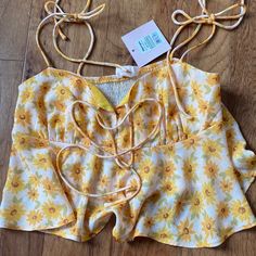 Tie Up Flowy Cropped Tank With Yellow Floral Pattern. Never Worn New With Tags Boutique Blouse Summer Daisy Print Top For Day Out, Lemon Print Summer Tops, Vacation Sleeveless Tops With Lemon Print, Sleeveless Tops With Lemon Print For Vacation, Cute Daisy Print Summer Tops, Summer Vacation Tops With Lemon Print, Yellow Floral Print Top For Beach Season, Yellow Lemon Print Beach Top, Yellow Floral Print Beach Top