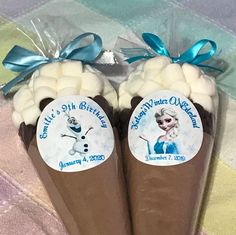 there are two chocolate cones with frosting on them, one is frozen queen and the other is snowman