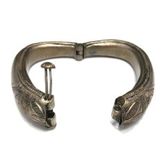 *Description: This is a great embossed design tribal bracelet with a hinge and plunger clasp which makes it very easy to take on and off from the 1940s. The plunger stays attached so you don't have to worry about loosing it. The bracelet has a gold wash, which I tested at 10K gold surface metal. The bracelet under the gold wash is a non-magnetic brass metal; probably mostly hollow. The shape of the bracelet is very unique and is more of a triangular shape with the flat portion on the bottom behi Historical Engraved Jewelry For Ceremonial Occasions, Vintage Carved Bracelets For Ceremonial Occasions, Vintage Ceremonial Bangle With Antique Finish, Vintage Bronze Ceremonial Bangle, Ceremonial Vintage Bronze Bangle, Antique Carved Bangle For Ceremonial Occasions, Antique Engraved Bronze Cuff Bracelet, Antique Carved Bangle For Ceremonial Events, Vintage Carved Jewelry For Ceremonial Occasion