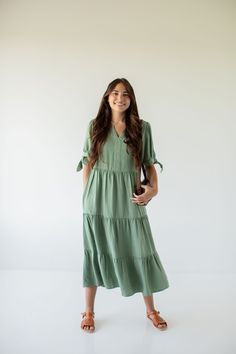 Add a pop of color with the "Kaia' midi dress! This midi dress features tie sleeves and a tiered silhouette, creating a flattering and comfortable ensemble. Pair with sandals and a shoulder bag for a charming and sophisticated vacation look! 100% Lyocell Unlined Machine Wash Cold Hang Or Lay Flat Do Not Bleach  Cool Ir Dusty Green, Vacation Looks, Layered Tops, Tie Sleeve, Skirt Leggings, Relaxed Style, Blouse Dress, Tops For Leggings, Exclusive Designs