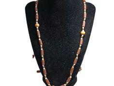 The brown ceramic beads look like wood. There are also white and beige/light brown round beads. The necklace measures 46 inches long which is long enough to double into a double-strand short necklace. Beige Necklace, Brown Ceramic, White And Beige, Hippie Necklace, Beige Light, Stone Gold, Gold Tone Necklace, Amethyst Necklace, Short Necklace