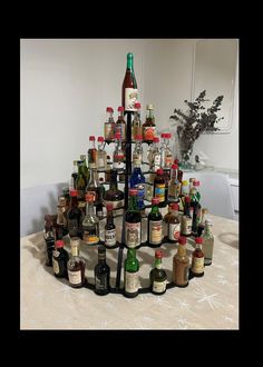 a christmas tree made out of bottles on a table