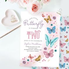 two birthday cards with butterflies on them next to pink roses and other items in the background