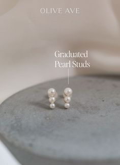 a pair of pearl studs with the words graduate pearl studs written below it