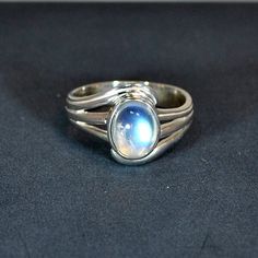 Sterling silver ring with blue moonstone setting, available in the following finger sizes:   UK sizes: K, L, N, O, Q & S.  U.S. sizes: 5 ½, 6, 7, 7 ½, 8 ½ & 9 ½.   DO NOT FORGET TO SEND YOUR FINGER SIZE WITH ORDER. Other stones available in same model: labradorite & lapis. One of the best selling rings. Technical details : silver weight 3gm./0,106oz.  Size of stone 8x6mm/0,32x0,24inch.  Width of ring including stone and silver 12mm/0,47inch.  Width of shank underneath 3,5mm/0,14inch. Celestial Silver Moonstone Ring, Silver Celestial Moonstone Ring, Silver Moon-shaped Celestial Moonstone Ring, Celestial Silver Opal Ring, Silver Celestial Jewelry With Oval Cabochon, Silver Celestial Opal Ring With Birthstone, Adjustable Silver Moon-shaped Moonstone Ring, Silver Moonstone Moon Shaped Ring, Silver Moonstone Crystal Ring In Moon Shape