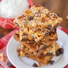 three pieces of granola bars stacked on top of each other with chocolate chips and nuts