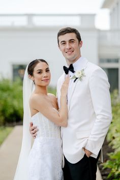 a bride and groom posing for the camera