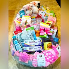 a basket filled with lots of toys on top of a floor next to a table