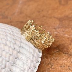 14KT yellow gold Fleur de Lis crown design ring. Pattern goes all the way around and does not have a sizing spacer bar in, however if you would like one, let us know before we cast. Wear this unique ring by itself or add an anniversary band to this. Sizes: 5, 6, 7, 8, 9 Width: 12mm Weight: 3.7g~ 4.4g Made in USA Made to order: please allow 7-10 business days prior to shipping Luxury Gold Rings With Crown Design, Classic Gold Rings With Crown Design, Luxury Yellow Gold Rings With Crown Design, Yellow Gold Crown Design Ring, Yellow Gold Rings With Crown Design, Fine Jewelry Yellow Gold Crown Design Ring, Gold Crown Design Ring, Gold Crown Shaped Promise Ring, Mens Ring Designs