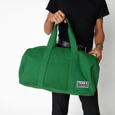 Made with 14 oz organic cotton canvas GOTS certified, low impact dyes Lead-free YKK metal zippers + fasteners Adjustable shoulder strap, up to 44" Outside drop in pocket, 10"H x 7.5"W Inside pocket, 9"H x 8.5"W 56L capacity, 13"H x 22"W x 12"D Made in a Fair Trade Certified Factory Handcrafted in Kolkata, India Durable and versatile, the Bumi Duffel Bag is sustainably and ethically made with 14-oz heavy duty Fairtrade organic cotton canvas. The perfect size for a spontaneous weekend getaway or w Handmade Backpacks, Gym Accessories, Duffel Bags, Types Of Bag, Designer Backpacks, Weekend Getaway, Daily Workout, Duffel Bag, Corporate Gifts