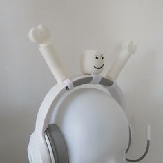 a white headphone with a smiley face on it's ear and two headset plugged in