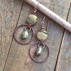 Earthy yellow and beige dangle earrings with rustic teardrop dangle and antiqued copper.Small, light-weight copper and Czech glass earrings that are perfect for your spring jewelry collection! The Czech glass is a beautiful, rustic, semi-transparent focal piece with a small glass teardrop dangle and antiqued copper ring.Product overview:- Made with Czech glass and antiqued copper- Total hanging length is 2", the ring is the diameter of a penny- Small, versatile and light-weight- Hypoallergenic e Earthy Yellow, Earthy Earrings, Orange Jewelry, Beaded Earrings Diy, Small Boho, Orange Earrings, Teardrop Dangle Earrings, Spring Jewelry, Rustic Jewelry