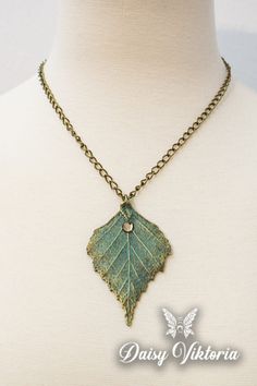 Green and Gold Fantasy Elven Fairy Leaf Necklace Gold And Green Necklace, Gold Nature-inspired Metal Necklace, Gold Patina Pendant Jewelry, Gold Pendant Jewelry With Patina, Nature-inspired Leaf Shaped Brass Jewelry, Gold Pendant Necklace With Patina, Gold Leaf-shaped Copper Jewelry, Handmade Green Leaf Necklace, Vintage Gold Leaf Jewelry