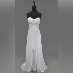 a white wedding dress on a mannequin