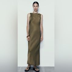 Sleeveless Midi Dress Made Of Viscose. Cowl Neck And Pleated Armholes. Outer Shell 100% Viscose Sleeveless Khaki Spring Dresses, Sleeveless Khaki Dresses For Spring, Sleeveless Khaki Dress For Spring, Elegant Sleeveless Khaki Dress, Khaki Sleeveless Dresses For Spring, Fitted Sleeveless Khaki Dress, Chic Sleeveless Khaki Midi Dress, Elegant Khaki Midi Dress, Elegant Khaki Midi Length Dress