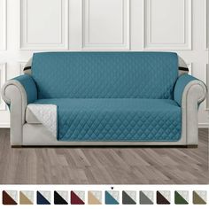 a couch covered in a blue quilted cover with white trims and various colors