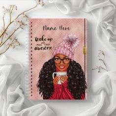 a spiral notebook with an illustration of a woman holding a coffee cup and wearing a pink knitted hat