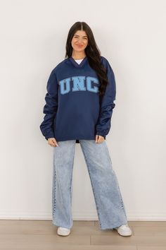 Stay comfortable and show your school spirit with our North Carolina Tar Heels Classic V-Neck Wind Shirt featuring a bold college logo. Designed for style and functionality, this lightweight layer offers wind protection with a timeless v-neck design, perfect for game days or casual outings. Collegiate Navy Top For Game Day, Navy Varsity Top For College, Varsity Style Team-colored School Top, Team-colored Varsity School Tops, Team-colored Varsity Tops For School, Navy Sporty Tops For Game Day, Navy Collegiate Top For College, Navy Collegiate Style Top, Collegiate Blue Tops For Campus