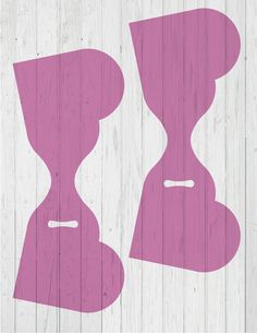 an image of two hourglasses on a wood background that is pink and white