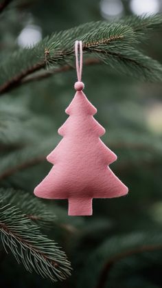 a pink ornament hanging from a tree