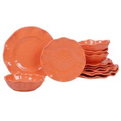 an orange dinnerware set on a white background