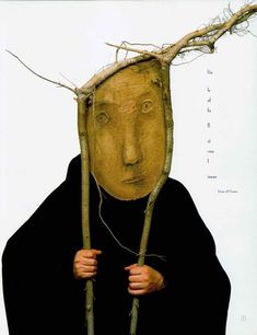 a man with branches on his head and hands holding twigs in front of his face