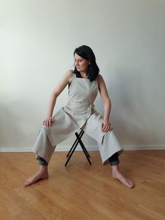 a woman sitting on a chair with her legs crossed