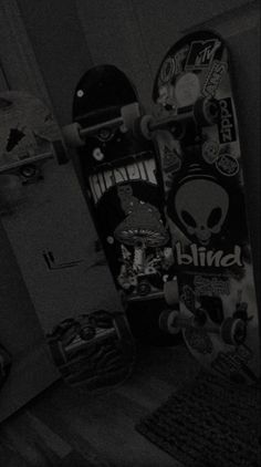 a skateboard that is upside down on the ground in a room with other skateboards