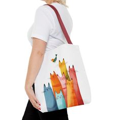 Brighten up your day with this adorable cat tote bag! Featuring a playful design of colorful cats and a cheerful bird, this bag is perfect for carrying your essentials while adding a touch of fun to your outfit. Made with durable materials, this tote is both stylish and functional. Key Features: Cute and colorful cat design High-quality, durable materials Spacious interior for plenty of storage    Perfect for everyday use or special occasions Order yours today and bring a little joy wherever you Playful Multicolor Shoulder Bag For Everyday, Cute Cat Print Tote Bag, Cute Colorful Bags For Everyday Use, Cute Cat Print Bags For Daily Use, Travel Tote Canvas Bag With Cat Design, Cute Multicolor Canvas Bag For Everyday Use, Cute Everyday Bags With Cat Design, Casual Canvas Bag With Cat Design For Travel, Casual Cat Design Tote Shoulder Bag