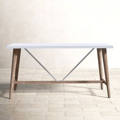 a white table sitting on top of a tiled floor