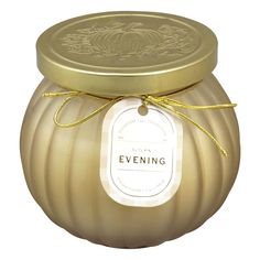 a candle with a label on it sitting in front of a white background that says evening