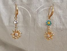 🌸 SPRING GLAM 🌸 Fresh flowers for spring A pair of Beautiful gold flower earring You can choose between a few finishes: 🌼 Dangle gold flower - The gold flower charm size about 10mm/1.5cm Round.It's made out of 2micron 14k gold plated with tiny Chz crystals In the shape of tiny flower in the middle. 🌼 Dangle 2 flowers - A colorful enameled flower with one of the colors available holding the gold flower. The tiny enameled flower size about: 0.5mm/1cm round. 🌼 Dangle gold flower and round diam Gold Earrings With 3d Flowers For Spring, Dainty Flower Earrings For Spring Wedding, Dainty Spring Flower Earrings For Wedding, Dainty Spring Wedding Flower Earrings, Dainty Dangle Earrings For Spring, Dainty Spring Dangle Earrings, Spring Dainty Dangle Earrings, Spring Wedding Dangle Flower Earrings, Gold Dangle Earrings With Flower Decoration